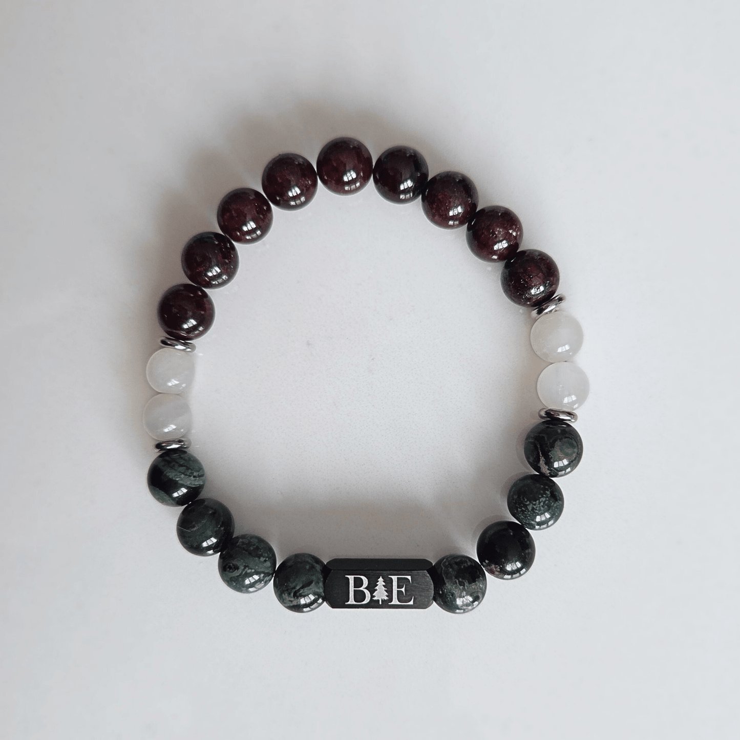 Men’s fertility support crystal bracelet with garnet, moonstone, and green aventurine, designed for strength, balance, and emotional resilience.