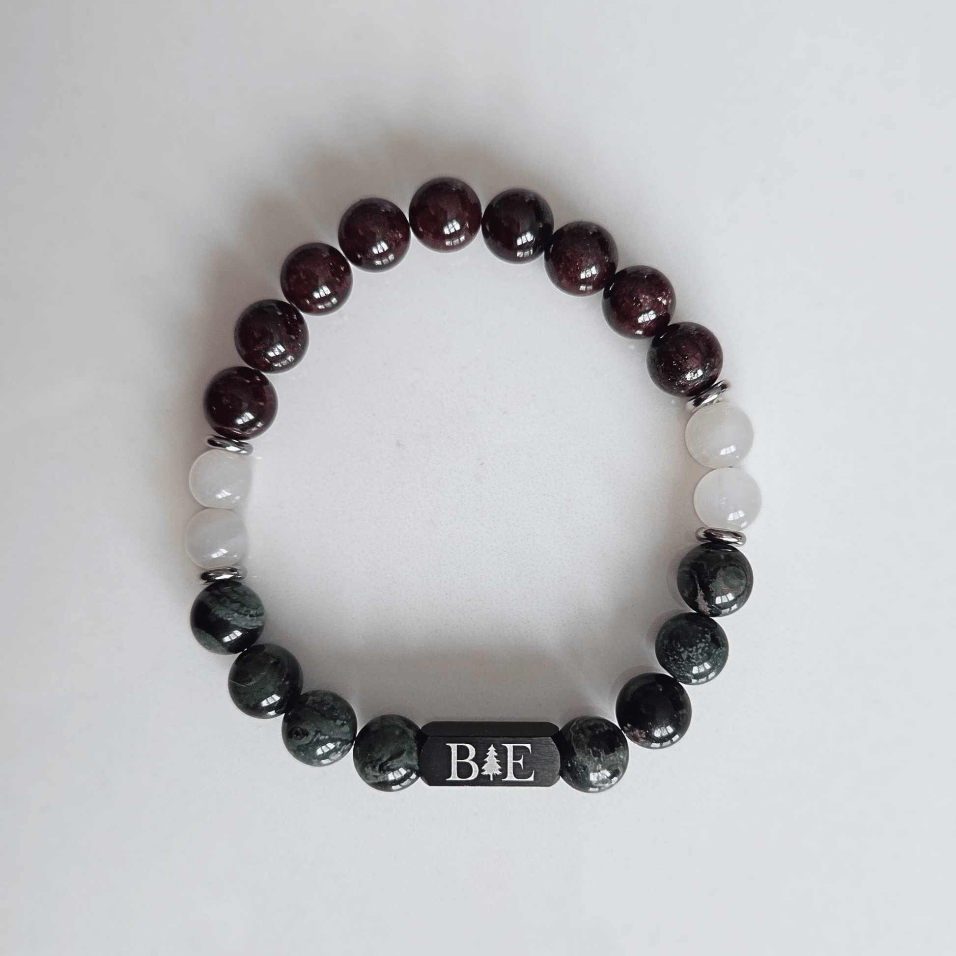 Men’s fertility support crystal bracelet with garnet, moonstone, and green aventurine, designed for strength, balance, and emotional resilience.